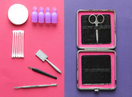 manicure set for shellac with cotton swabs and pads on a pink purple background close upの写真素材