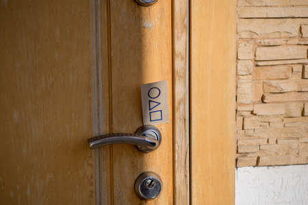 Russia, Krasnodar - 05.11.2021. Business card with invitation to play squid on the door lockのeditorial素材
