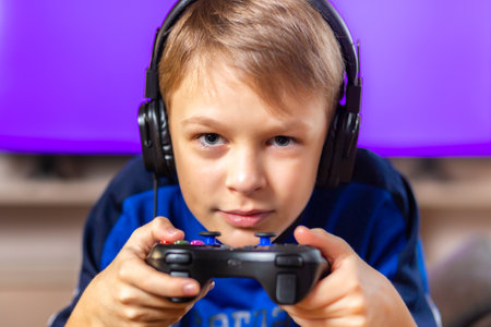 Young gamer playing online video games while streaming on social media. Blurred background and...