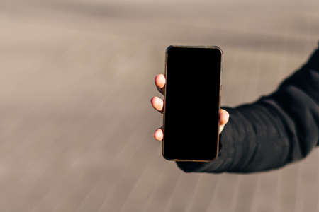 Phone mockup with black screen in female handの写真素材