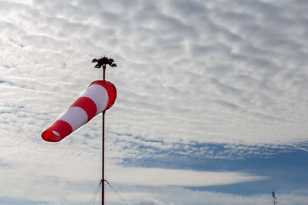 Windsock with cloudy sky in the backgroundの写真素材