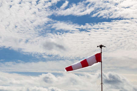 Windsock with cloudy sky in the backgroundの写真素材