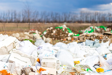 Construction debris on the background of green grass and forest.