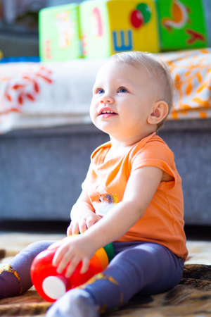 A child collects a rainbow-colored constructor on a blurred background.の写真素材