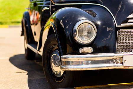 Old retro vintage Volga GAZ-21 in black on the street on a blurred background.の写真素材