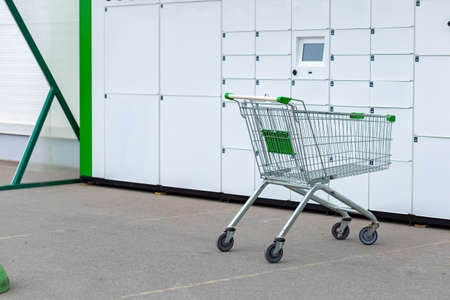 Consumer basket on wheels for shopping against the background of mailboxes.の写真素材