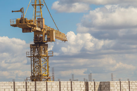 construction crane on the background of the sky and white clouds