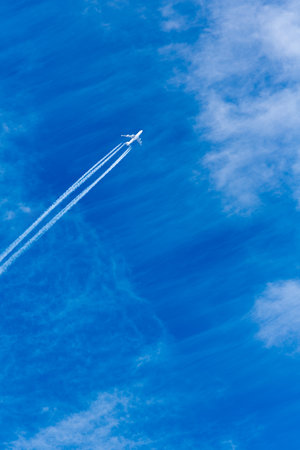 Passenger plane in the sky viewed from the ground. blue sky and clouds