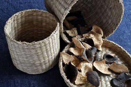 Dried orange peels in small baskets small baskets made of reed, grass and bamboo.の写真素材