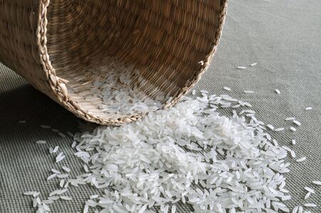 A nearly emptied basket made of reed, with very few rice left inside.の写真素材