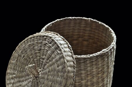 A basket made of reed with cover widely opened.の写真素材