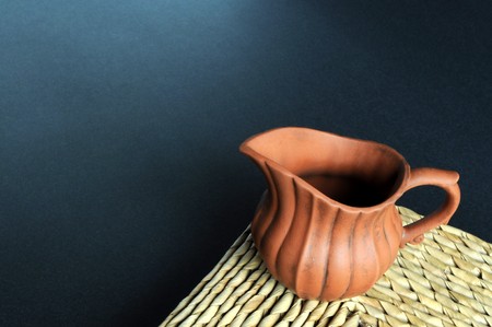 An old clay pot of Chinese tea set on grass mat.の写真素材