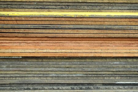 A pile of wooden planks in different colors.の写真素材