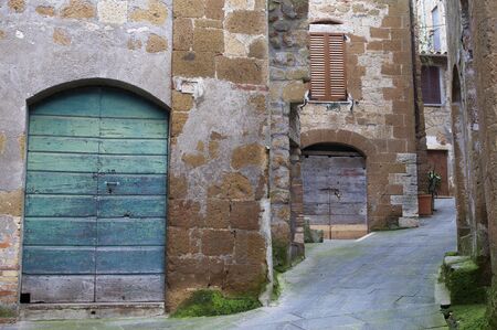 Alley with colorful wooden doors in Pitigliano