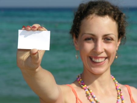 girl with paper for text on beachの写真素材