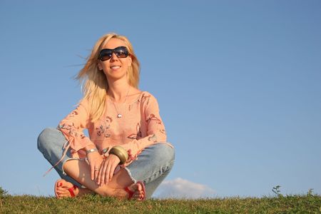 woman with sunglasse sit on grassの写真素材