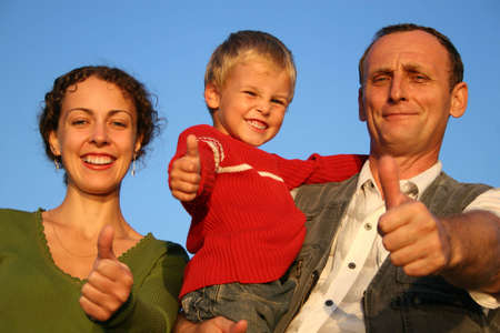 boy, mother and grandfather giving ok