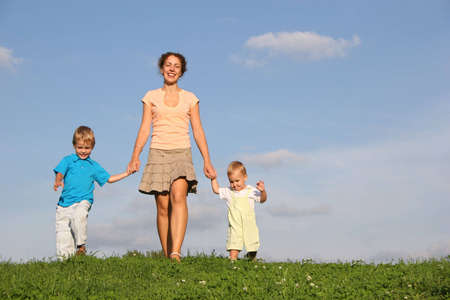 mother with children on meadowの写真素材