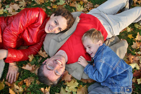 family on autumn leaves