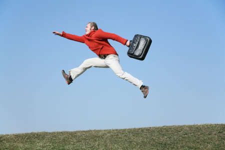 run fly man with bagの写真素材