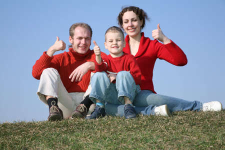 family with bou OK gesture on meadow