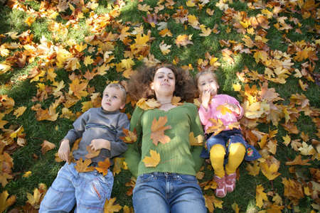 woman with the son and the daughter they lie on the grass 2
