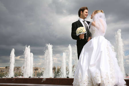 bride with the fiance against the background of the fountainsの写真素材