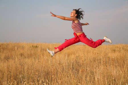young woman jump on the meadow