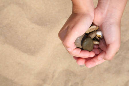 Stones in hands of the girlの写真素材