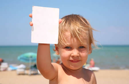 The child holds a paper.の写真素材