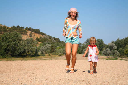 mother and daughter run on the beachの写真素材