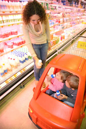 mother with the children in the supermarketの写真素材