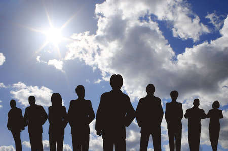 Business people with leader silhouette on skyの写真素材