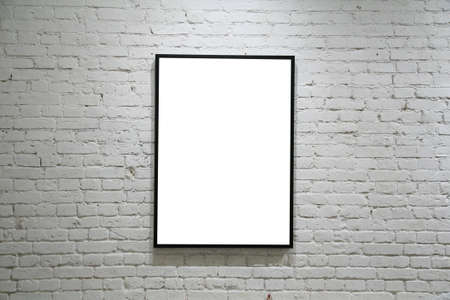 one black frame on white brick wallの写真素材