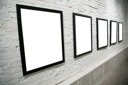 row of black frames on white brick wallの写真素材