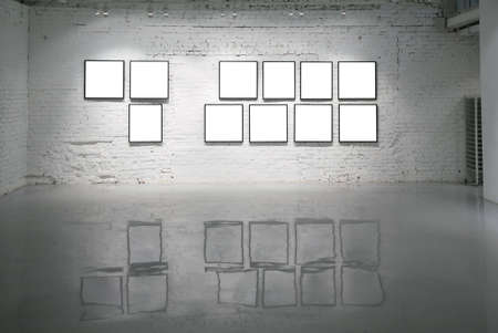 frames on white brick wall and reflections on floorの写真素材