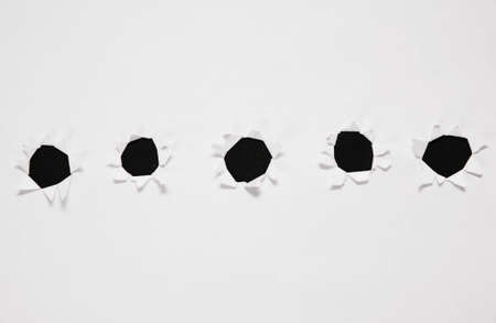 sheet of paper with row of holesの写真素材