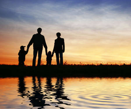 family of four on sunset sky, waterの写真素材
