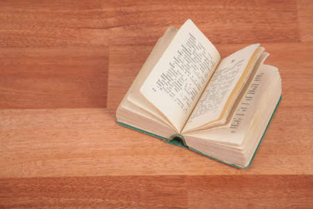 Opened book on wooden floor