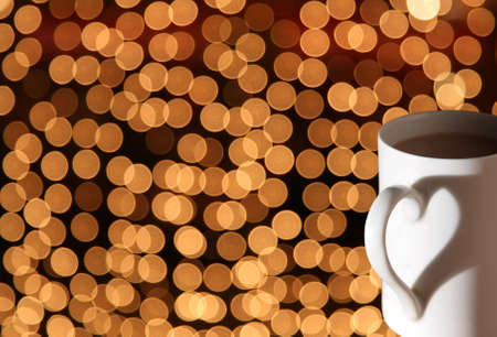 cup with shadow heart on bokeh lightsの写真素材