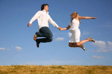 couple jump on meadowの写真素材