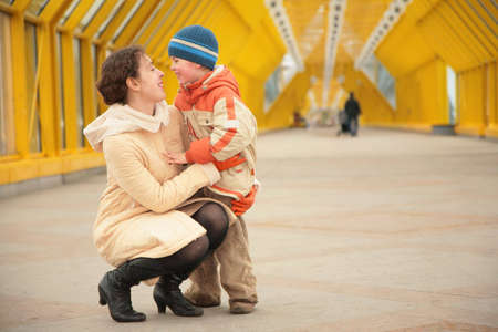 mother and son look each other on footbridgeの写真素材