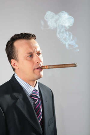 businessman smokes a cigarの写真素材