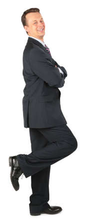 happy businessman stands on one leg,  lean one's elbows の写真素材