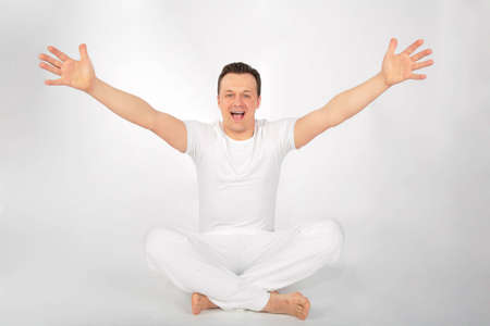  man in sports suit,  cross-legged and  hands dissolved in  sidesの写真素材