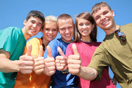 Group of friends in multicolor  shirts make gestures by fingers