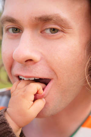 Child touches the father for lip
