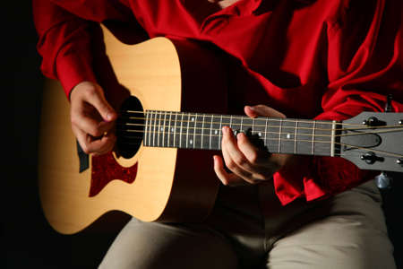 Close-up hands with guitar