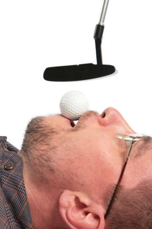 Lying man holds in mouth ball for golf of boss