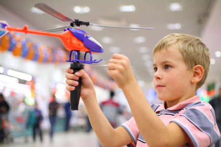 Boy in shop with toy helicopterの写真素材